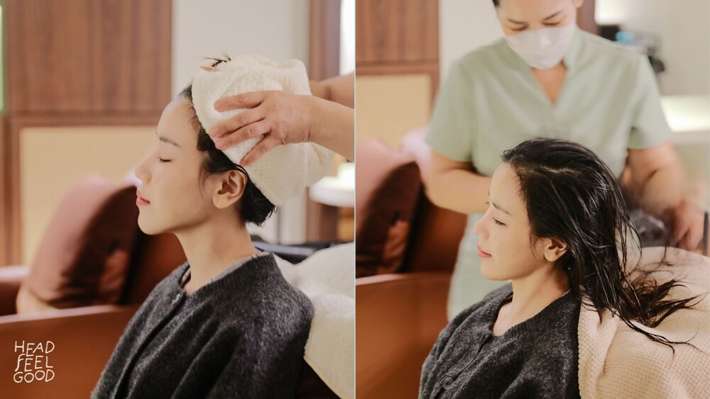 A woman is enjoying a relaxing spa massage focused on her head