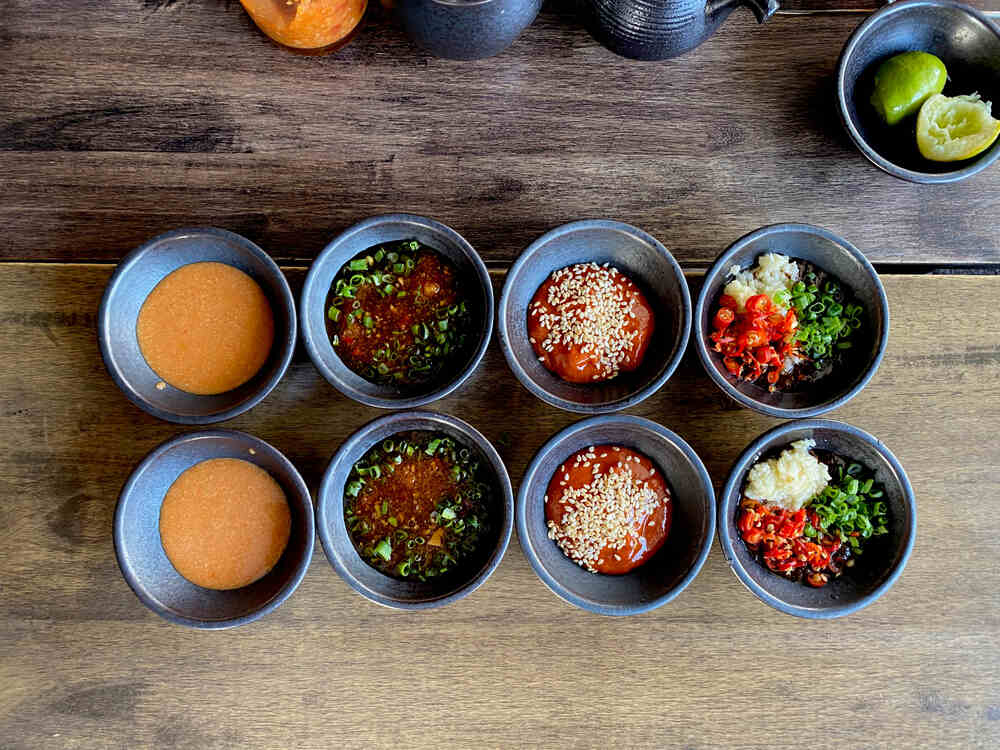 Popular mala dipping sauce recipes elegantly arranged on a wooden table